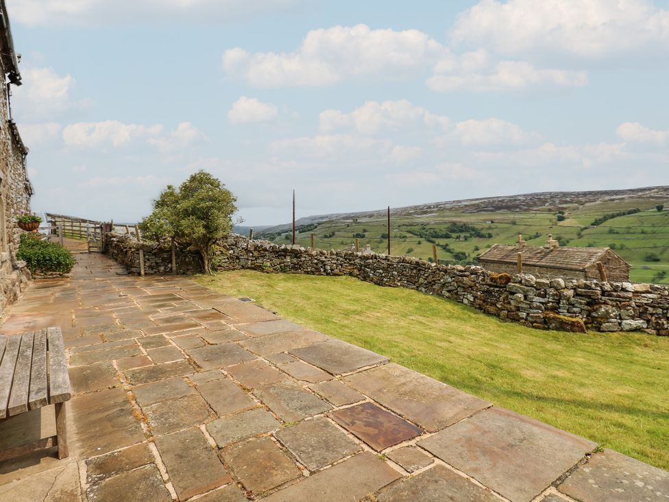 An outdoor area with a stone path and grass at High Smarber in Low Row near Reeth