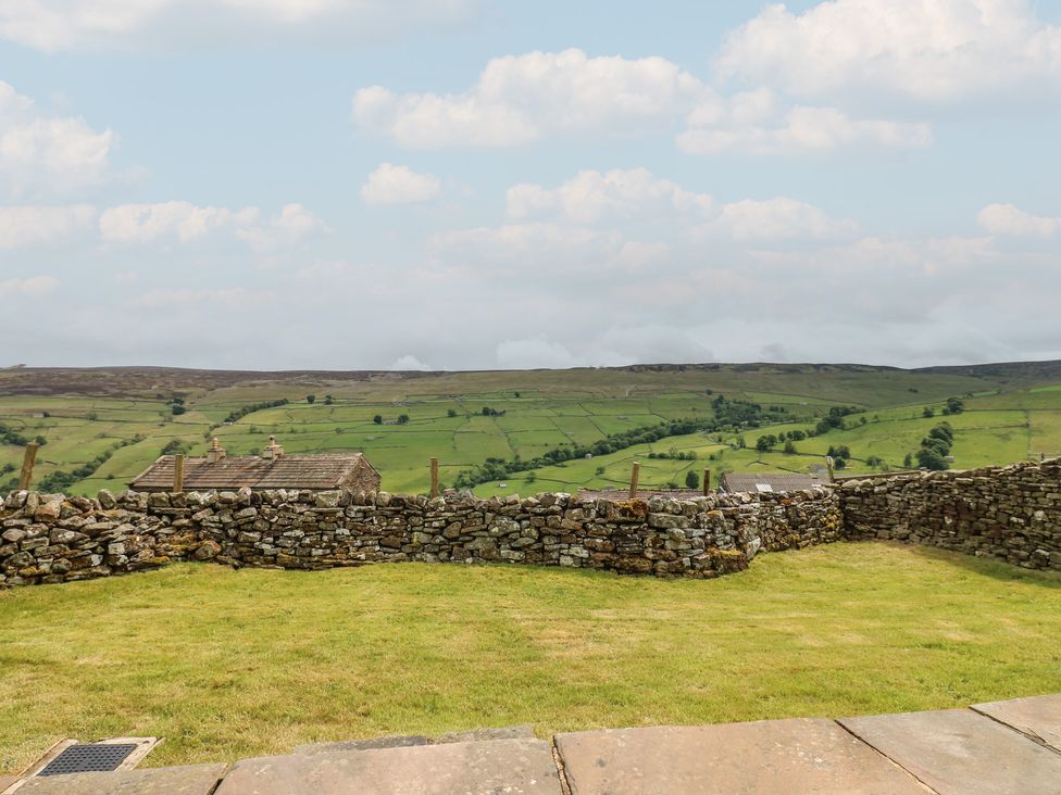 A view of rolling hills and a stone wall at High Smarber in Low Row near Reeth