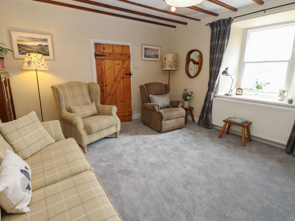 A living room with a sofa and armchair at High Smarber near Reeth