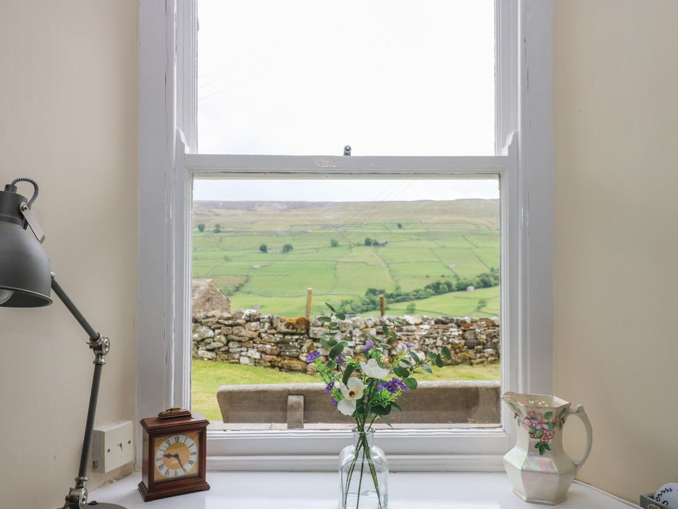 A window with a view and vases at High Smarber in Low Row near Reeth