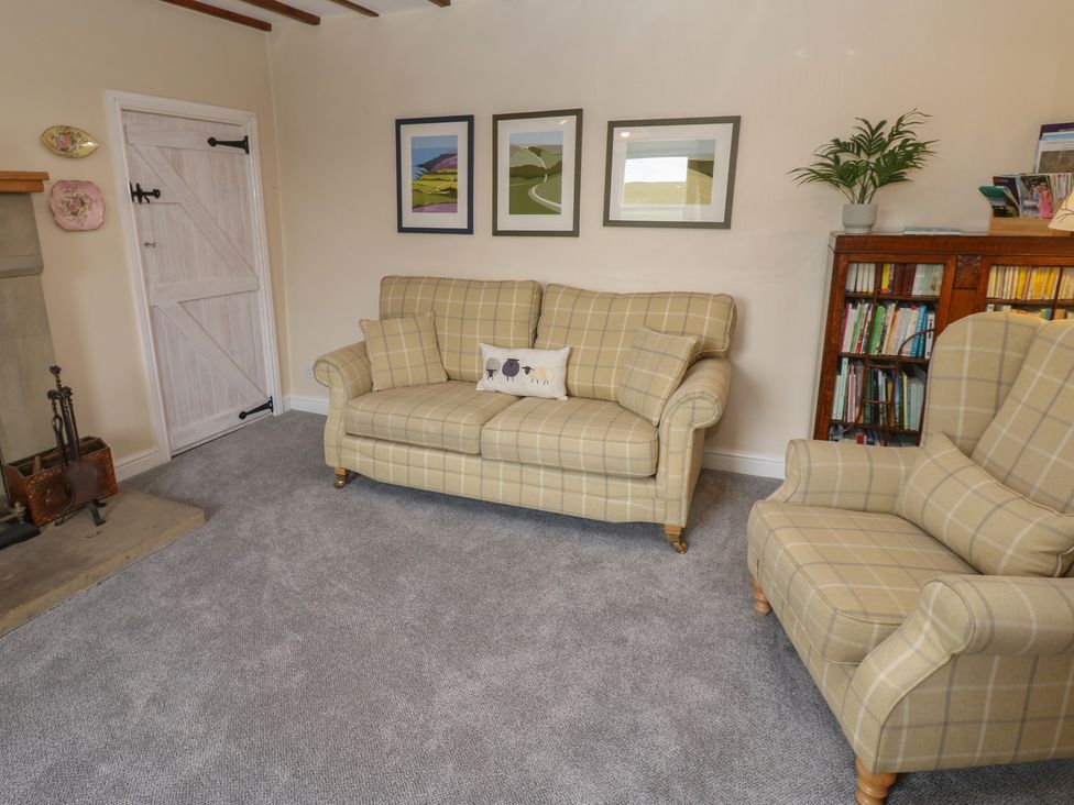 A living room with a sofa and armchair at High Smarber near Reeth