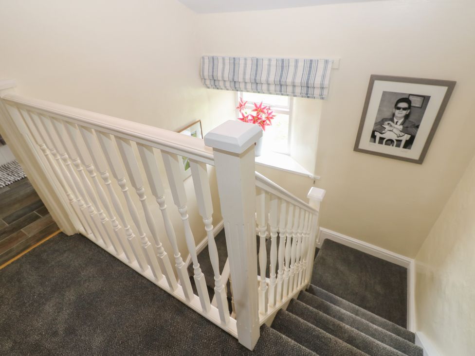 A stairway with a handrail and window at High Smarber in Low Row near Reeth