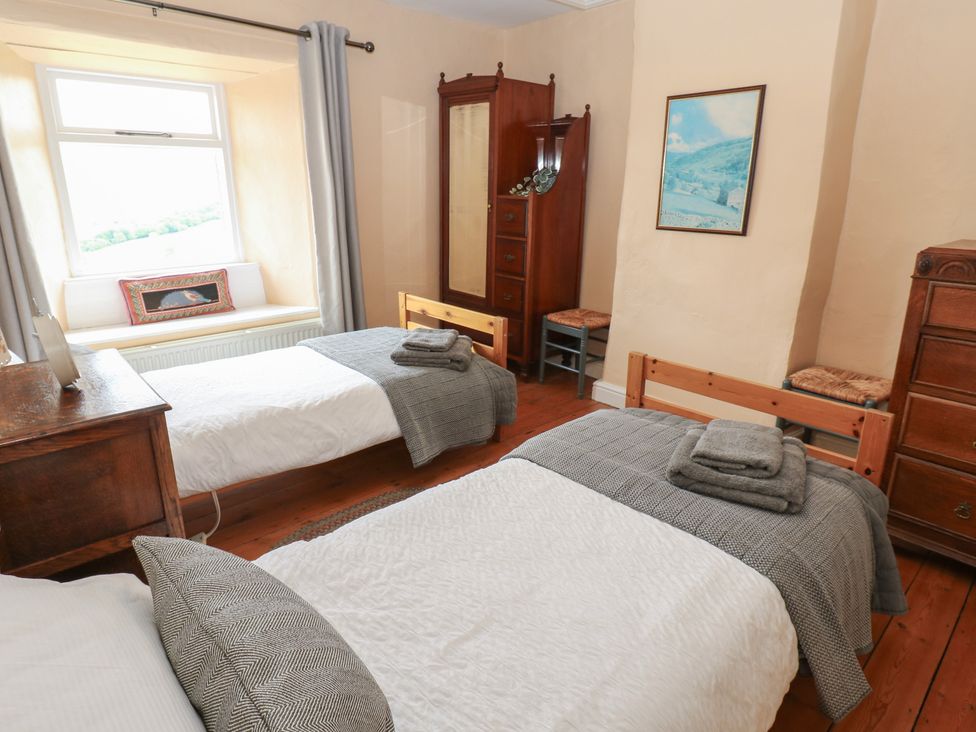 A bedroom with two beds and furniture in High Smarber Low Row near Reeth