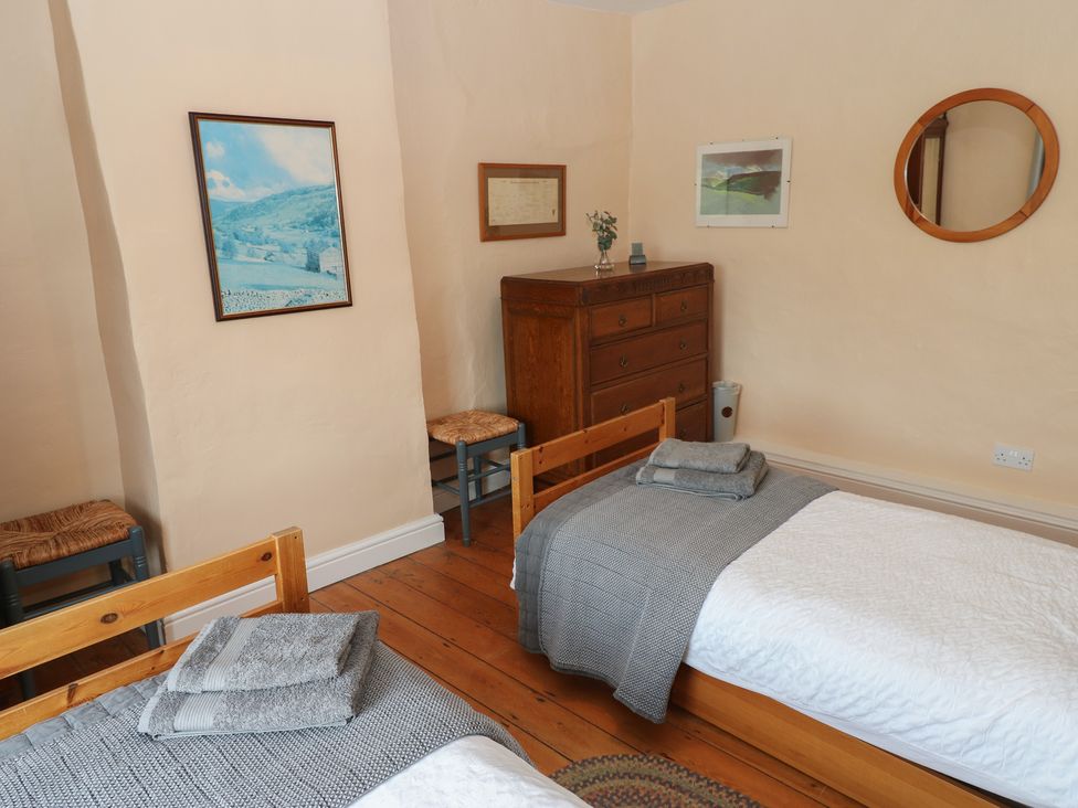A bedroom with two beds and a chest of drawers at High Smarber in Low Row near Reeth