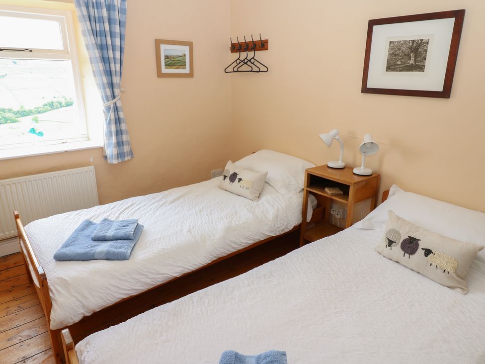 A bedroom with two single beds at High Smarber in Low Row near Reeth