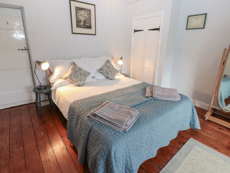 A bedroom with a bed and lamps at High Smarber in Low Row near Reeth