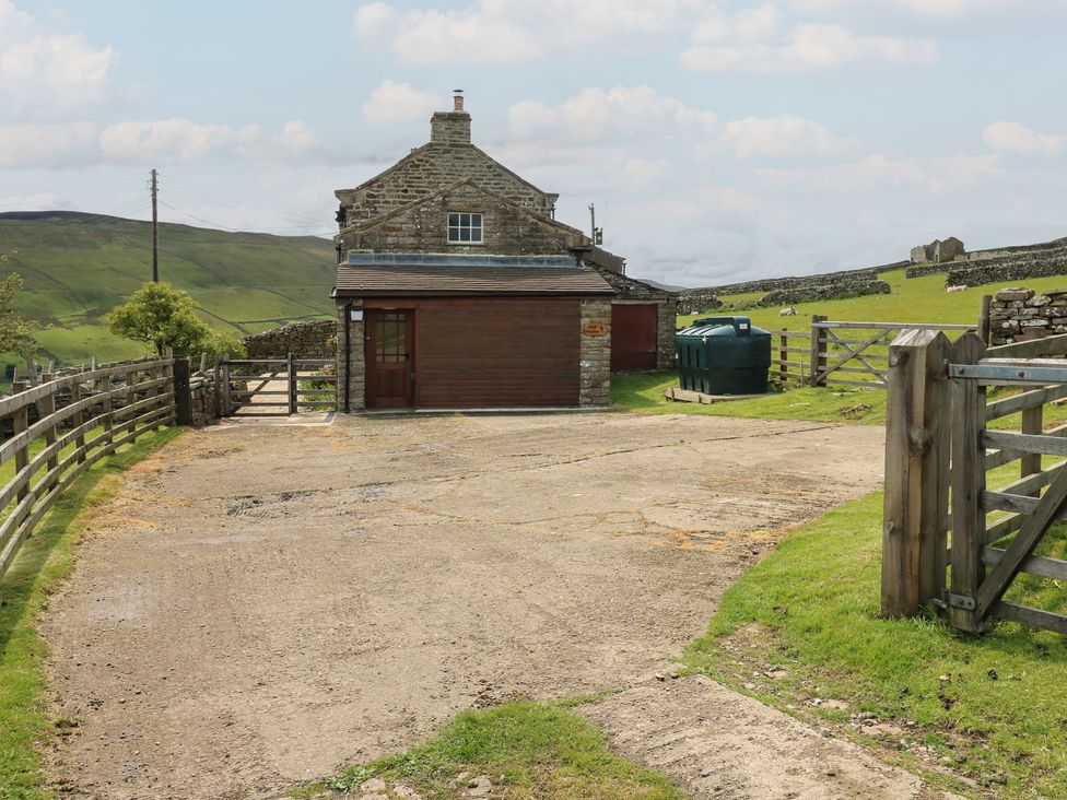 An outdoor area with a building and driveway at High Smarber in Low Row near Reeth