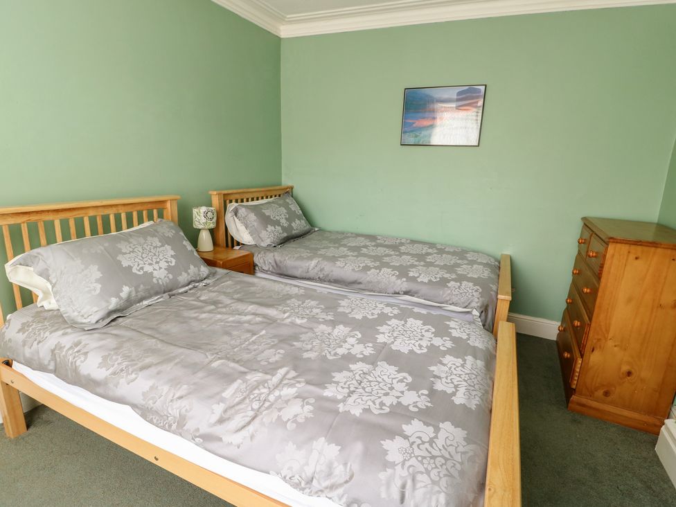 A bedroom with two beds and a chest of drawers at Halford Hill in Llanberis