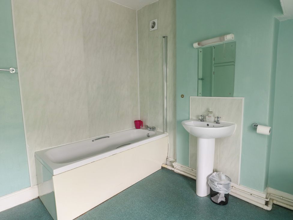A bathroom with a bathtub and sink at Halford Hill Llanberis