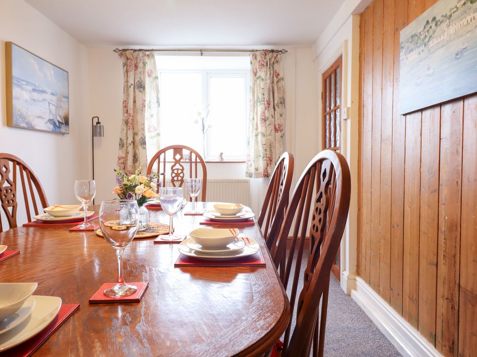 A dining room with a wooden table and chairs at Bryn Re Trawsfynydd near Llan Ffestiniog and Dolgellau