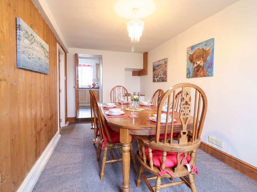 A dining room with a wooden table and chairs at Bryn Re Trawsfynydd near Llan Ffestiniog and Dolgellau