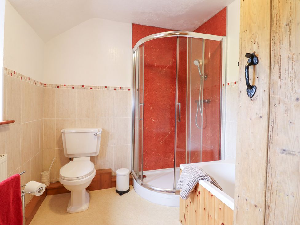 A bathroom with a shower, toilet, and bathtub at Bryn Re Trawsfynydd near Llan Ffestiniog and Dolgellau