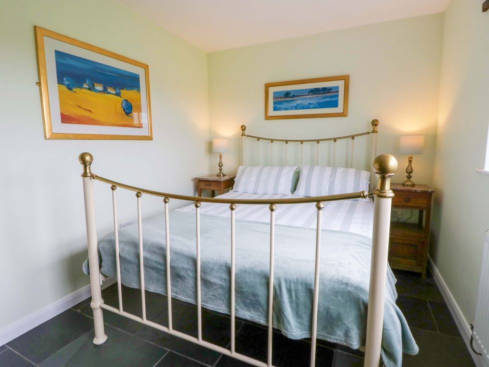 A bedroom with a bed and bedside tables at Blaenffynnon Bach in Trelech near Crymych