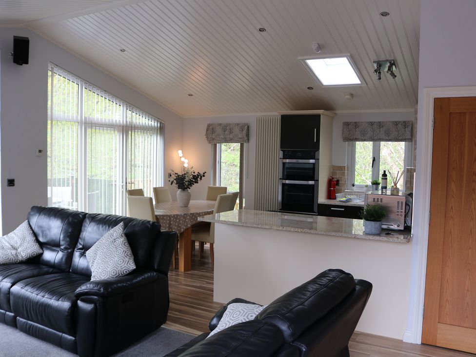 A living room with a kitchen island and seating area at High View Lodge White Cross Bay near Troutbeck Bridge