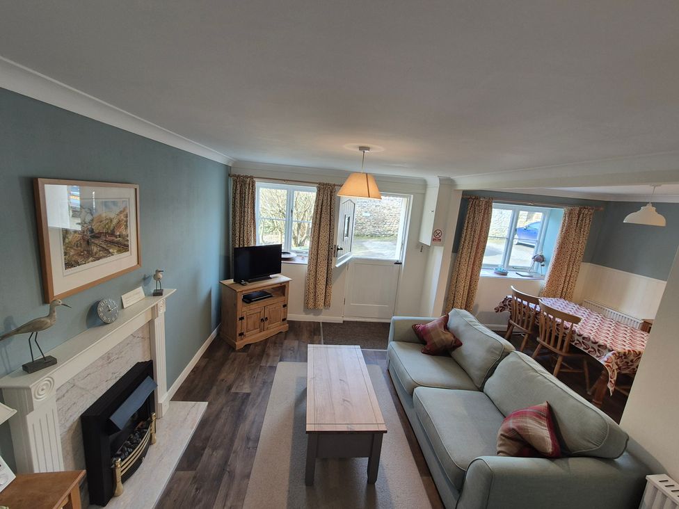 A living room with a sofa and television at Westgate Cottage in Pickering