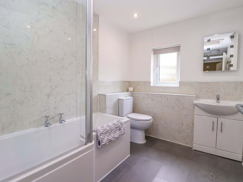 A bathroom with a bathtub and shower at The Granary in York