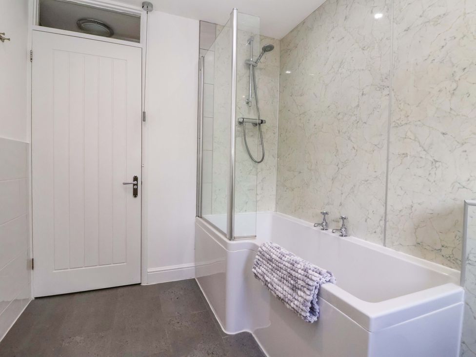 A bathroom with a bathtub and shower at The Granary in York