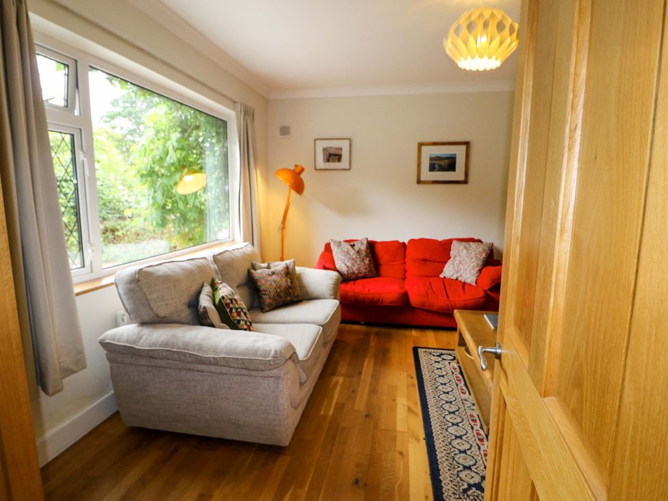 A living room with a sofa and armchair at Rowantree in Beaufort, County Kerry