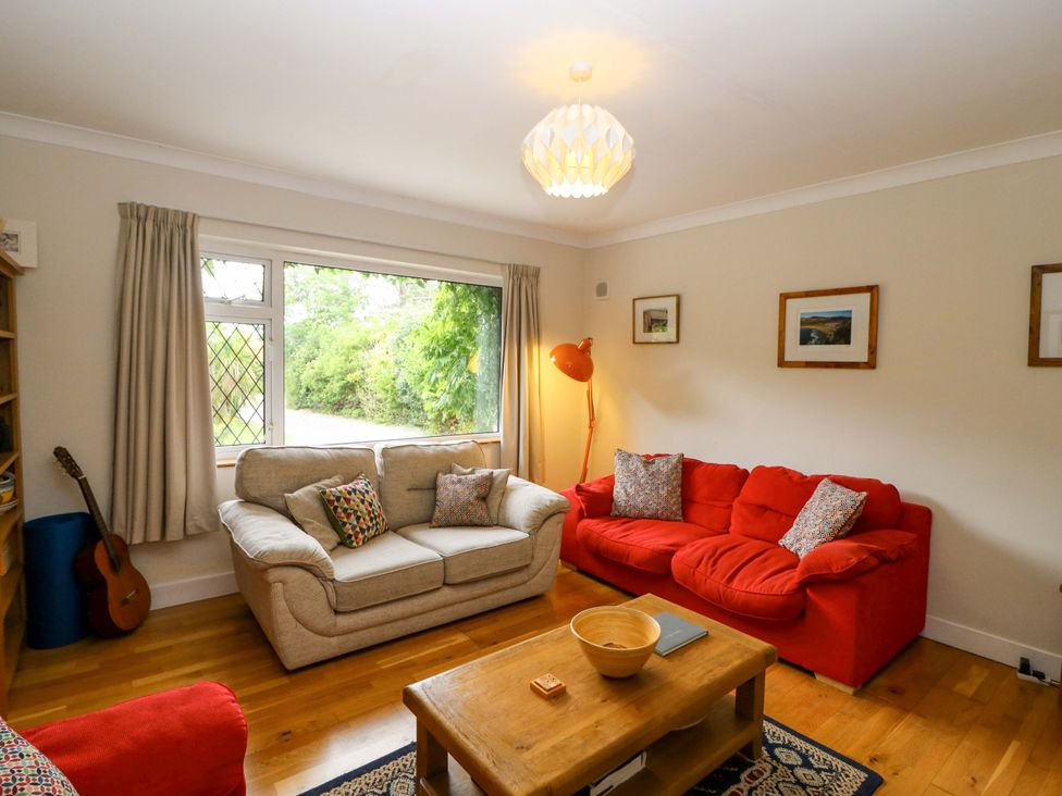 A living room with a sofa and guitar at Rowantree in Beaufort, County Kerry