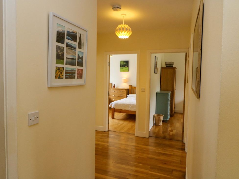 A hallway with a photo frame and a view into a bedroom at Rowantree, Beaufort, County Kerry