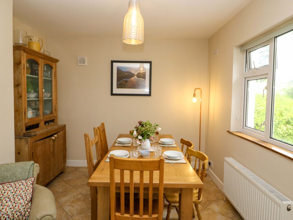 A dining room with a table and chairs at Rowantree, Beaufort, County Kerry