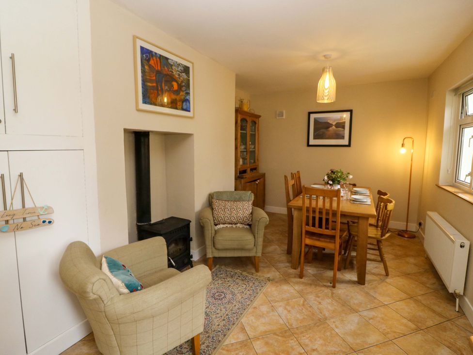A dining room with a table and chairs at Rowantree, Beaufort, County Kerry
