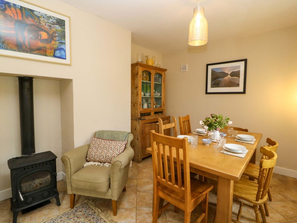 A dining room with a wooden table and chairs at Rowantree in Beaufort, County Kerry