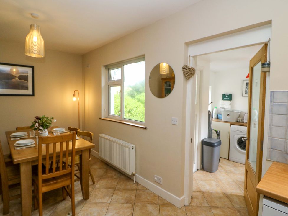 A dining room with a table and chairs at Rowantree in Beaufort, County Kerry