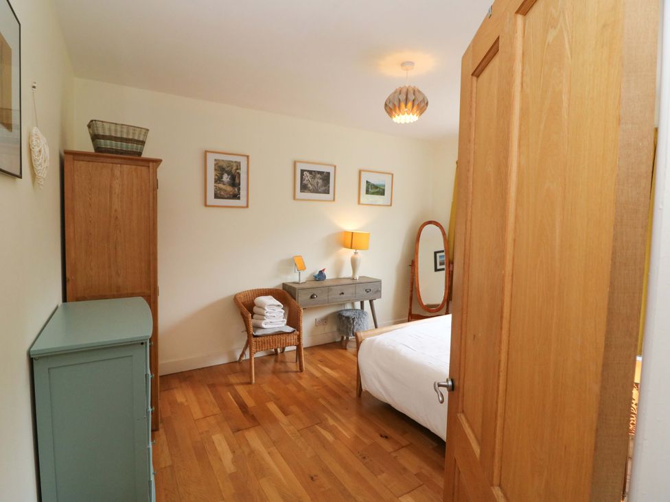 A bedroom with a bed and desk at Rowantree in Beaufort, County Kerry