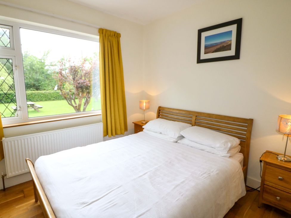 A bedroom with a bed and a window at Rowantree in Beaufort, County Kerry