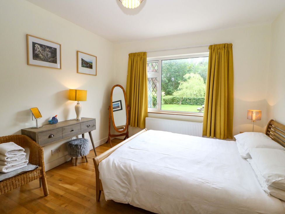 A bedroom with a bed and dresser at Rowantree Beaufort, County Kerry