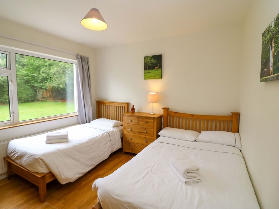 A bedroom with two beds and a dresser at Rowantree in Beaufort, County Kerry