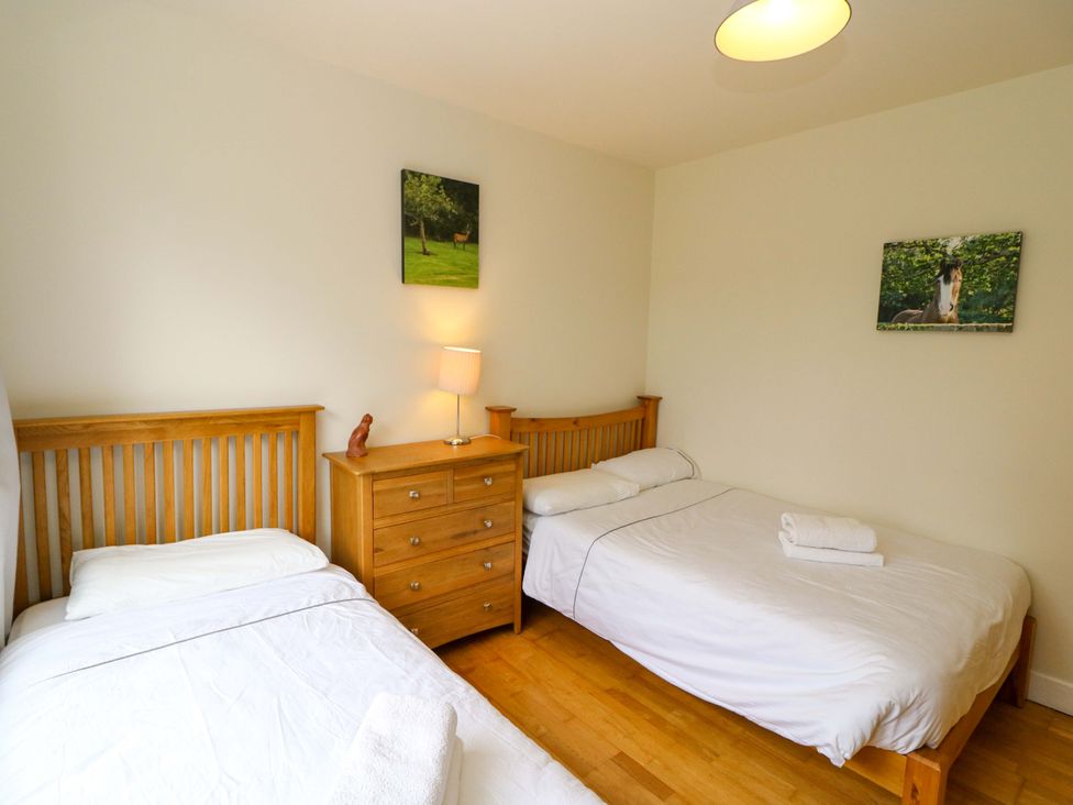 A bedroom with two beds and a dresser at Rowantree in Beaufort, County Kerry