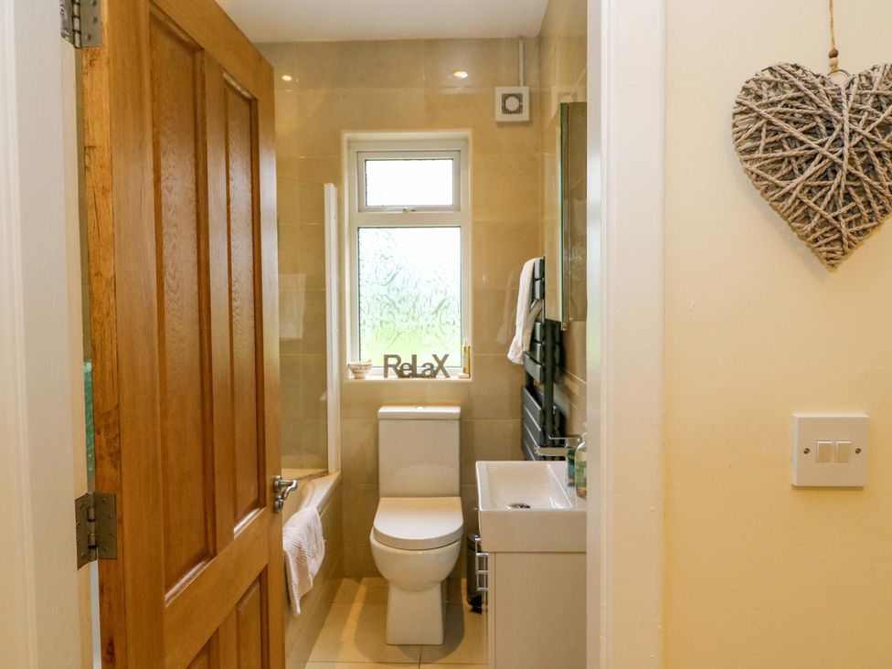 A bathroom with a toilet and sink at Rowantree in Beaufort, County Kerry