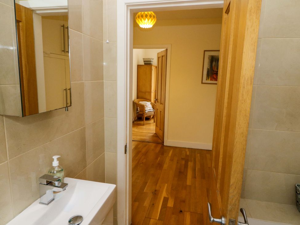A bathroom with a sink and mirror at Rowantree, Beaufort, County Kerry