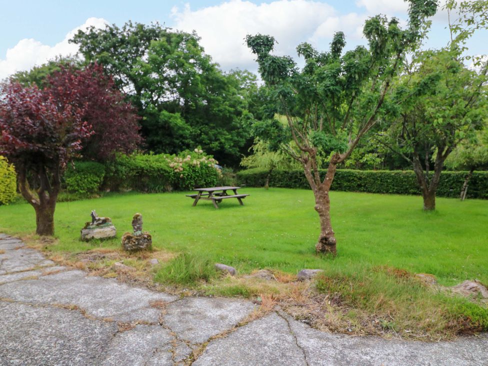 A garden with a picnic table and trees at Rowantree, Beaufort, County Kerry