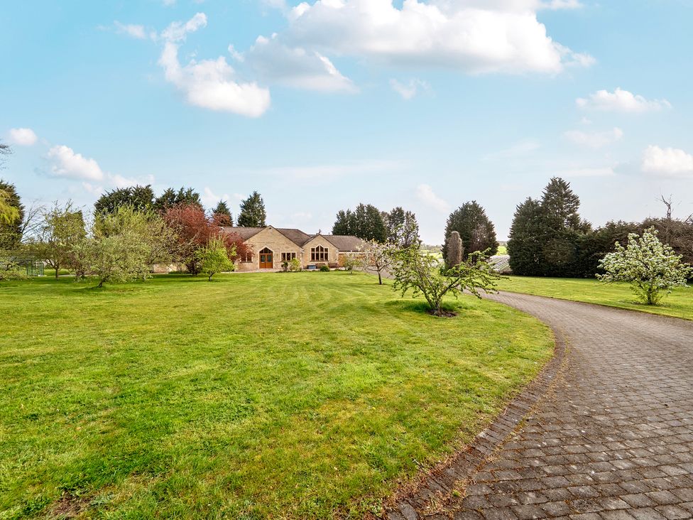 A house with a driveway and trees at Manor House in Chesterfield