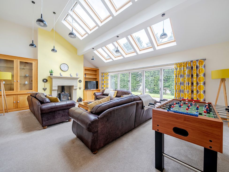 A living room with a foosball table and sofas at Manor House in Chesterfield