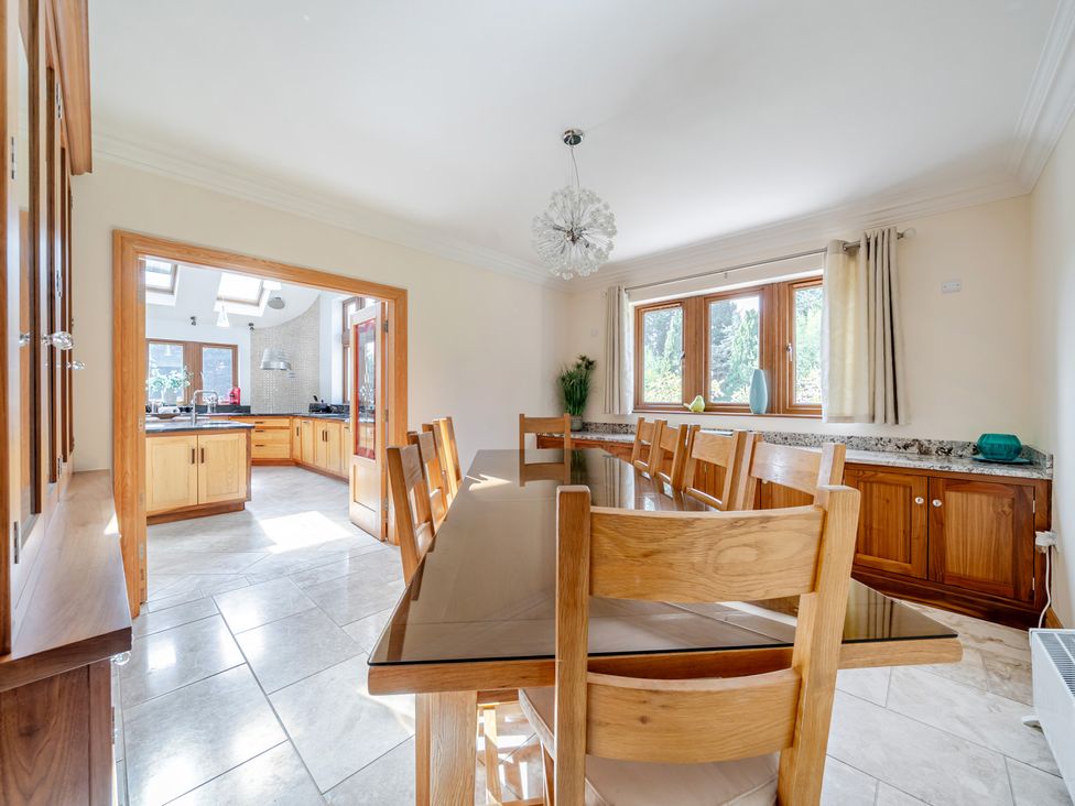 A dining room with a long table and chairs at Manor House in Chesterfield
