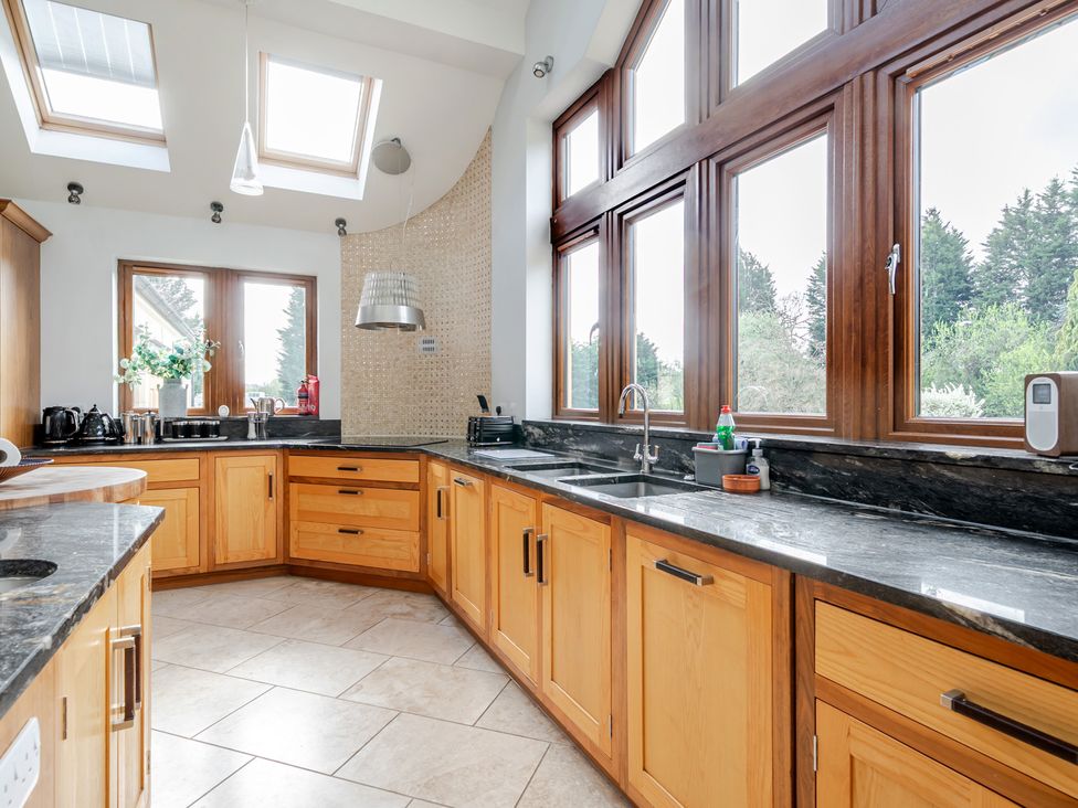 A kitchen with wooden cabinets and countertop at Manor House in Chesterfield