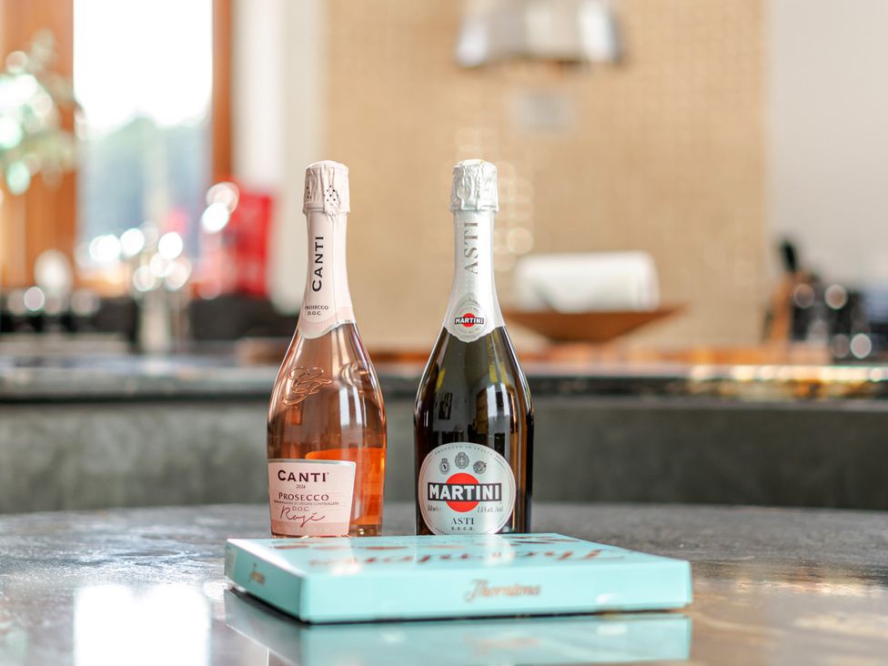 Two bottles of sparkling wine and a blue box in a kitchen at Manor House Chesterfield