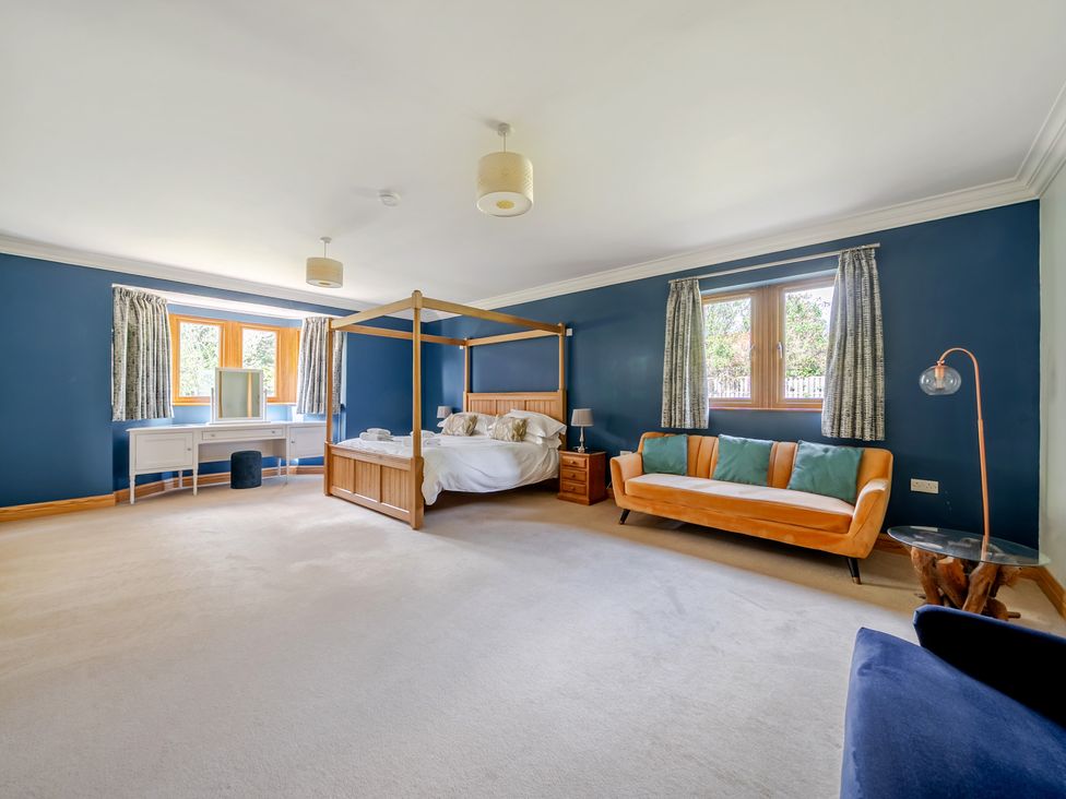 A bedroom with a four-poster bed and a sofa at Manor House in Chesterfield