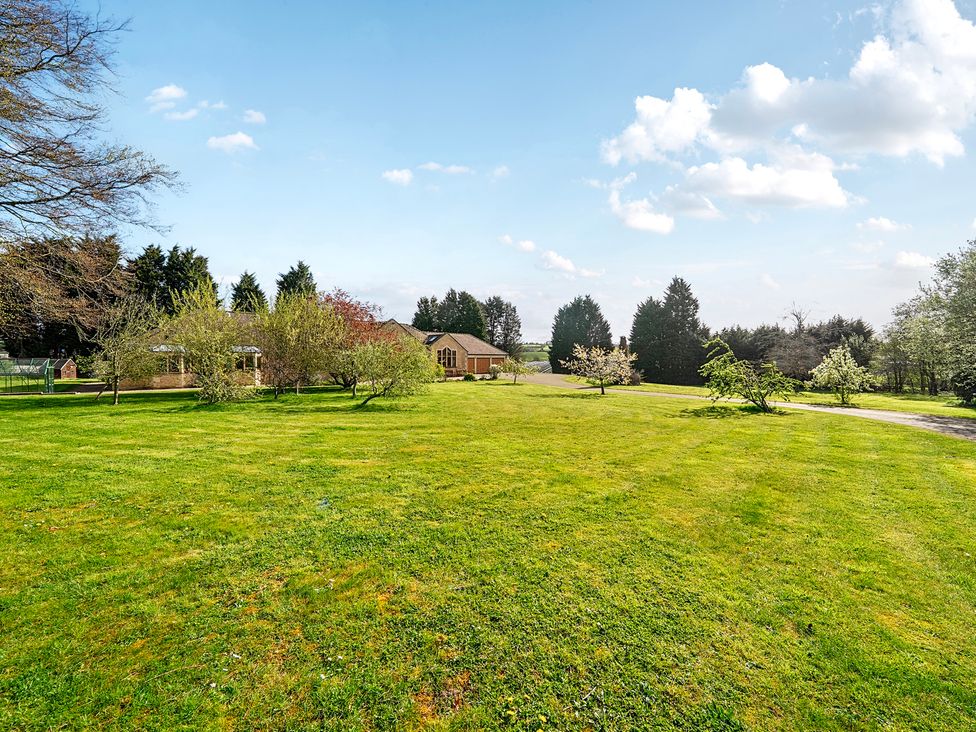 A house surrounded by grass and trees at Manor House Chesterfield