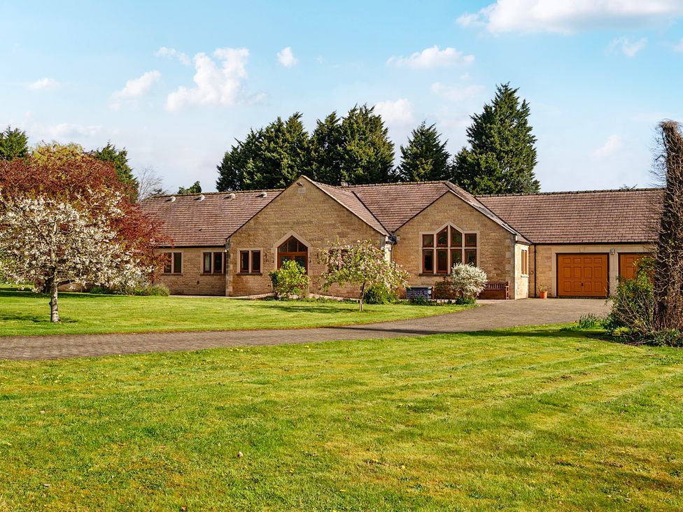 A house with a garage and landscaped garden at Manor House in Chesterfield