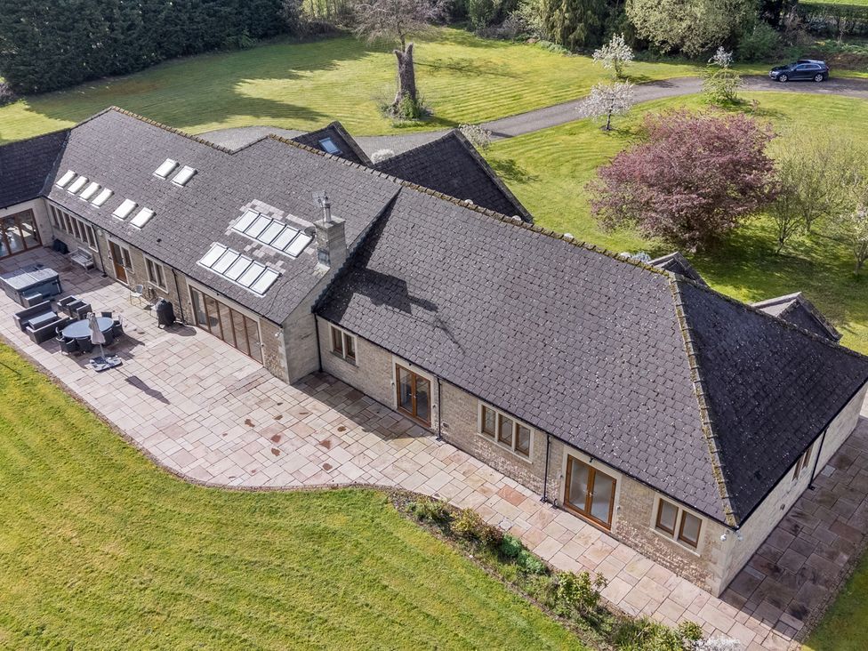 An outdoor view of a house with a patio and lawn at Manor House Chesterfield