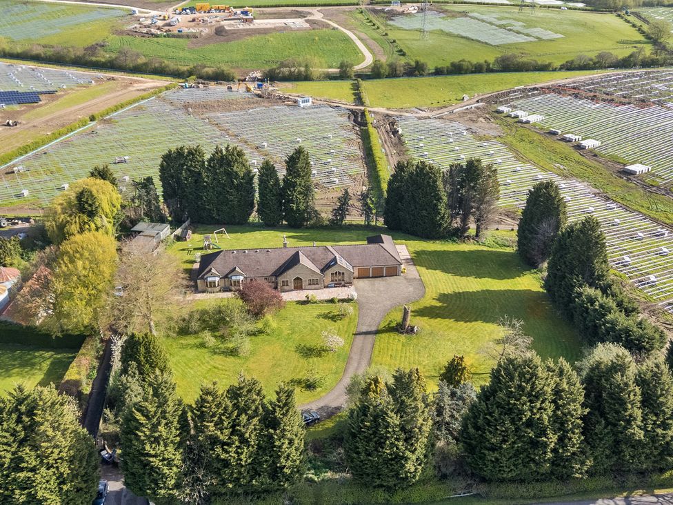 An aerial view of a house with a garage and trees in the yard at Manor House Chesterfield