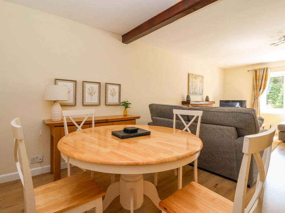A living room with a dining table and sofa at The Milking Parlour in York