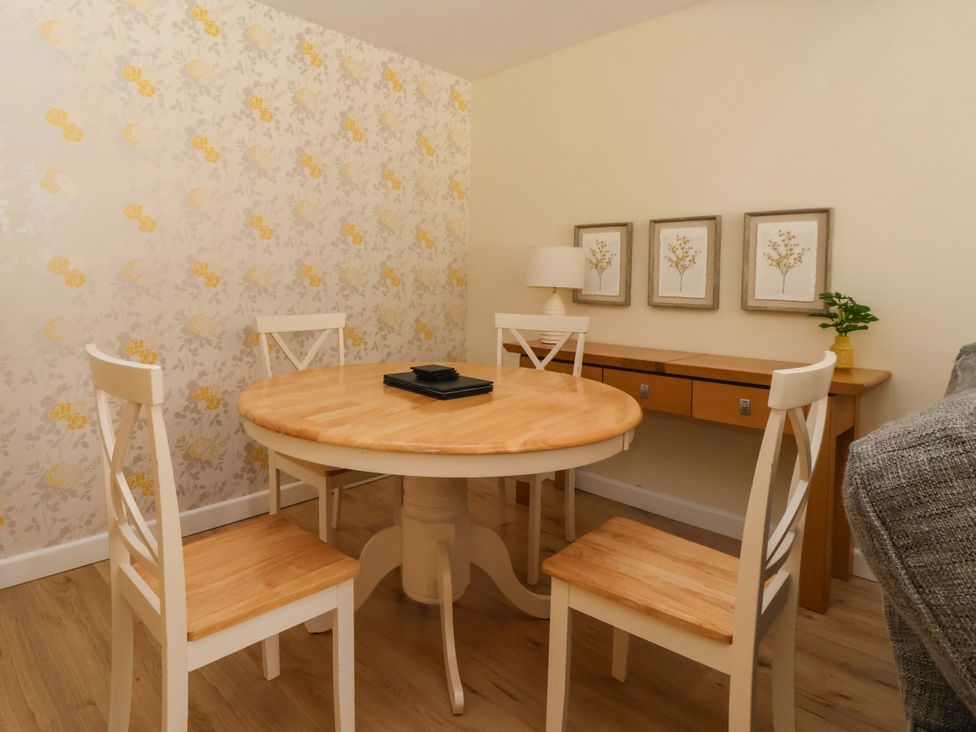 A dining room with a round table and four chairs at The Milking Parlour in York