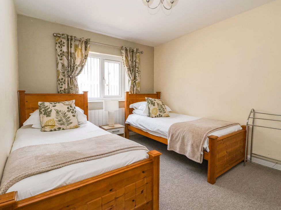 A bedroom with two beds and a window at The Milking Parlour in York