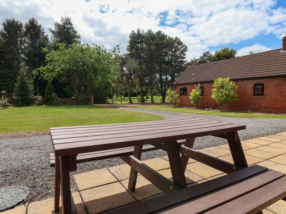 A picnic table with grass and trees at The Milking Parlour in York
